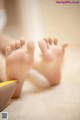 A close up of a baby's feet on the floor.