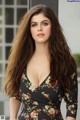 A woman in a floral dress posing for a picture.